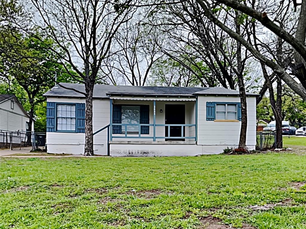 a view of a house with a yard and tree