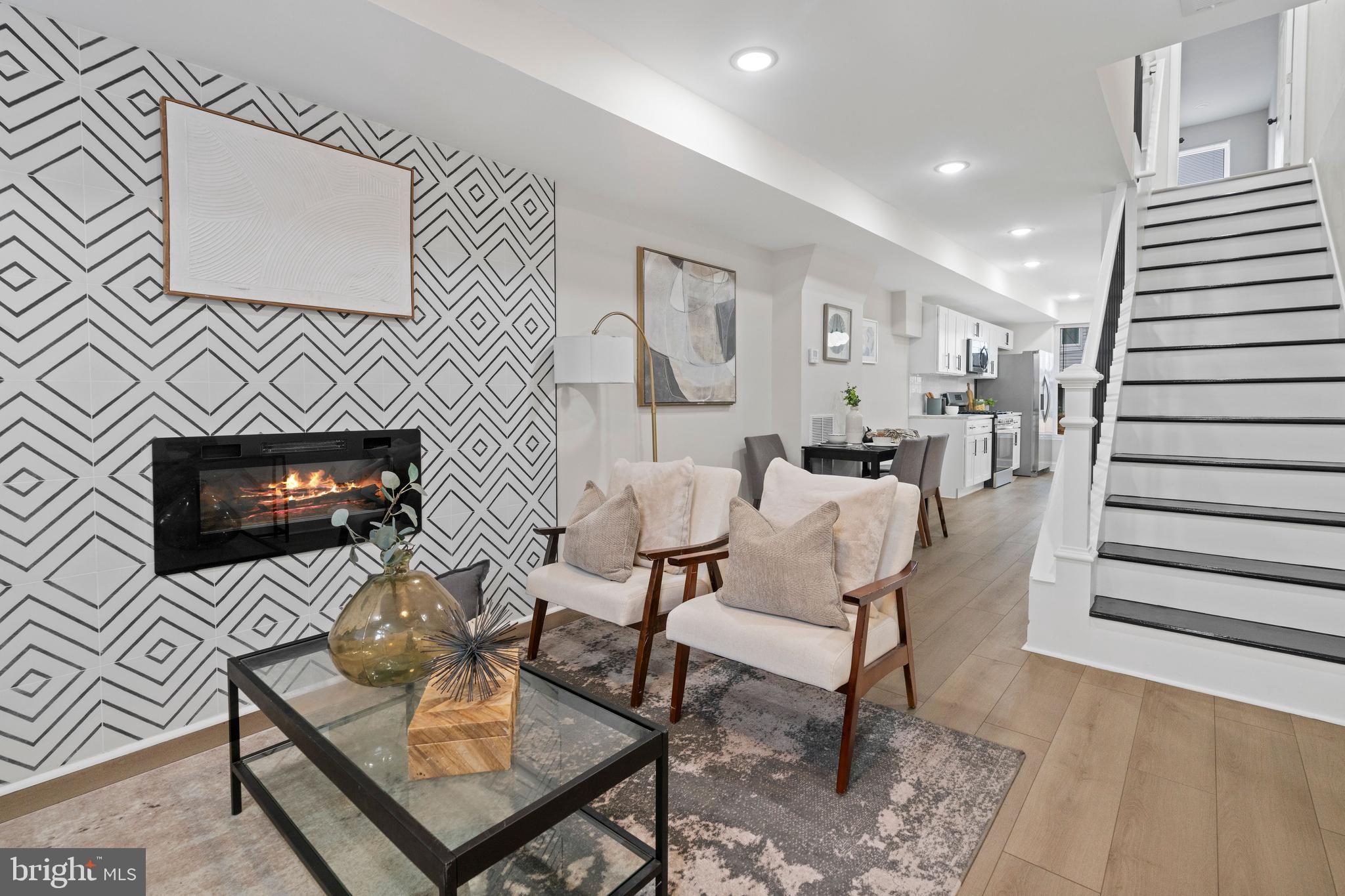 a living room with furniture and a fireplace