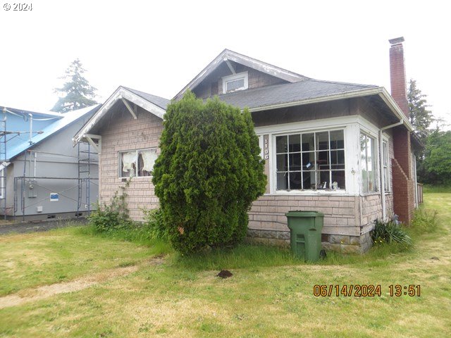 a front view of a house with a yard garage and outdoor seating