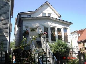 a front view of a house with plants