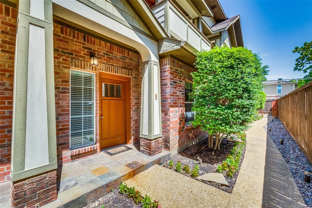 a view of a brick house with plants