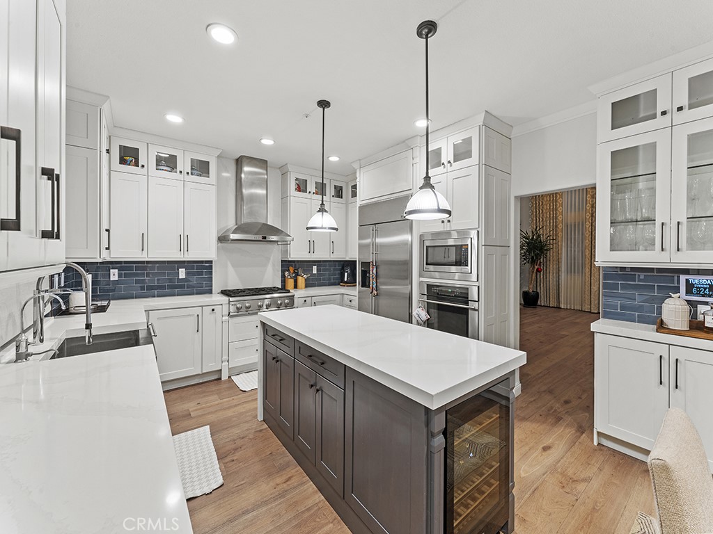 a large kitchen with stainless steel appliances kitchen island granite countertop a sink and cabinets