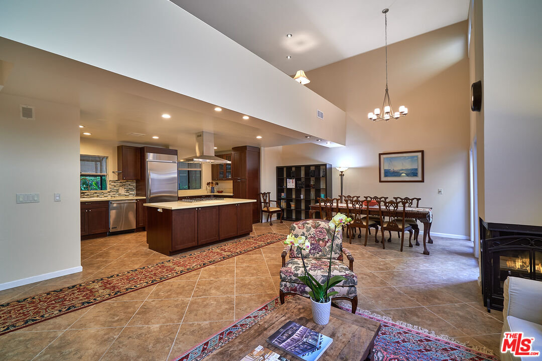 a living room with lots of furniture and kitchen view