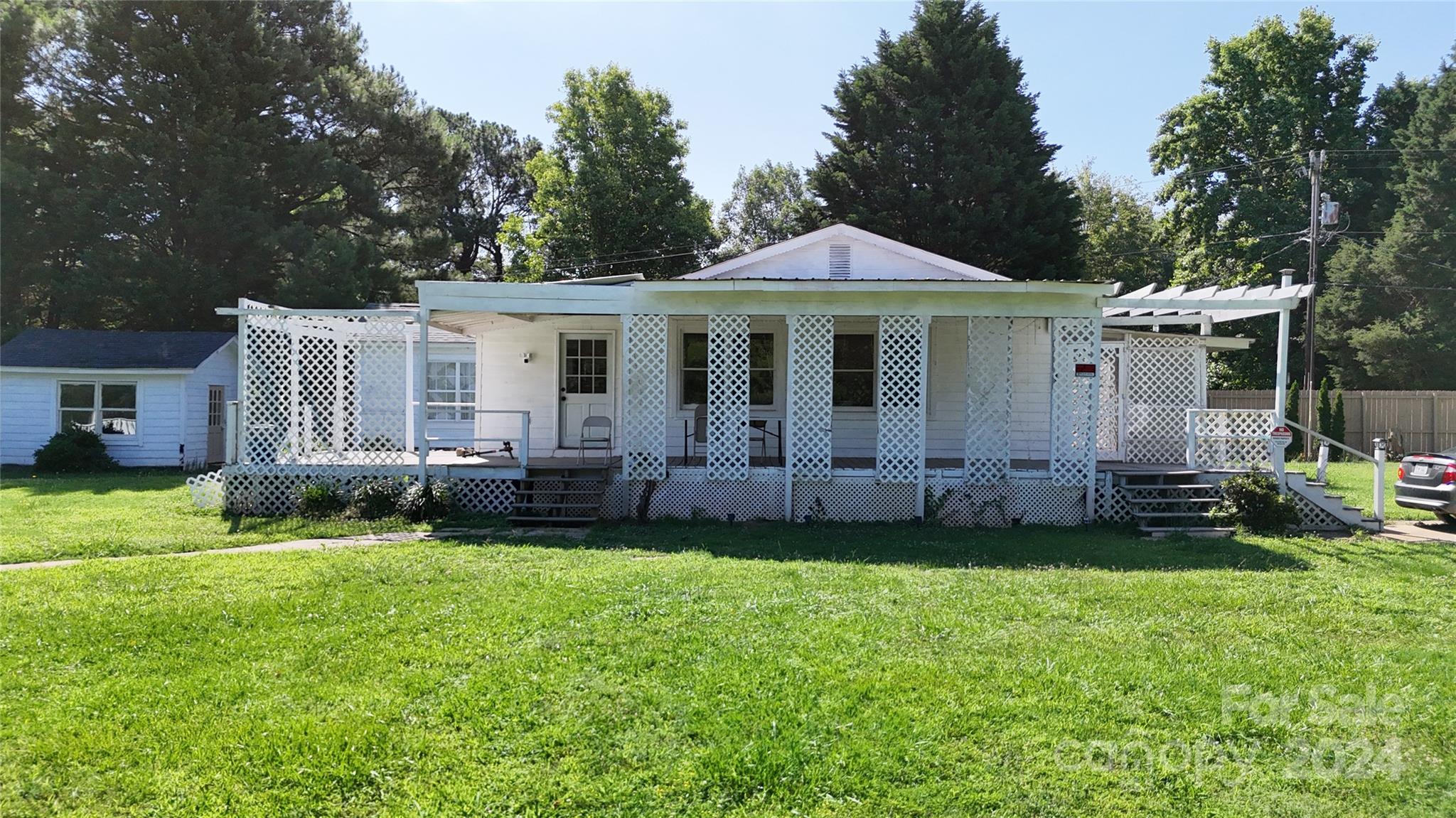 a view of a house with a yard and sitting area