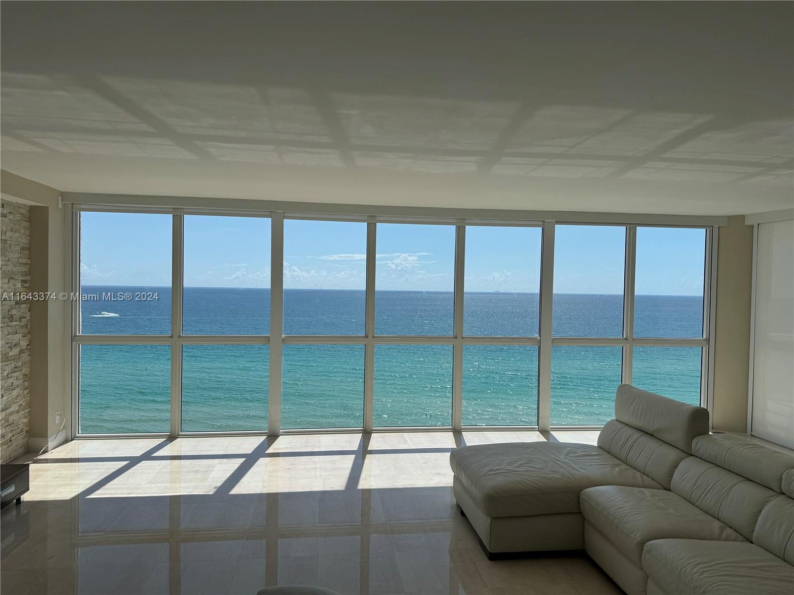 a living room with a large window and a couch