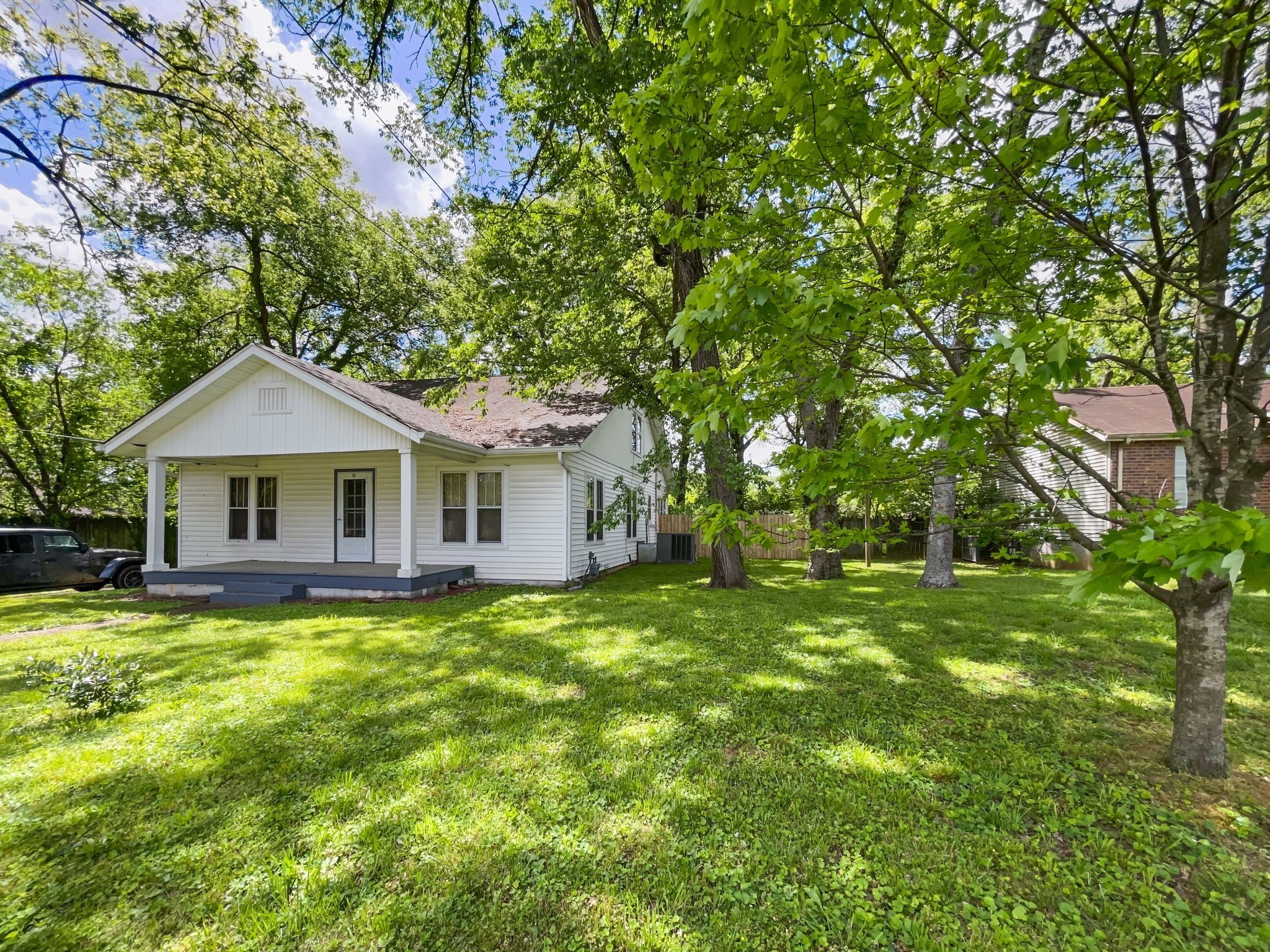 a front view of a house with yard and green space