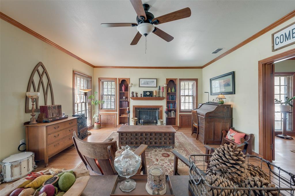 a living room with furniture fireplace and a window