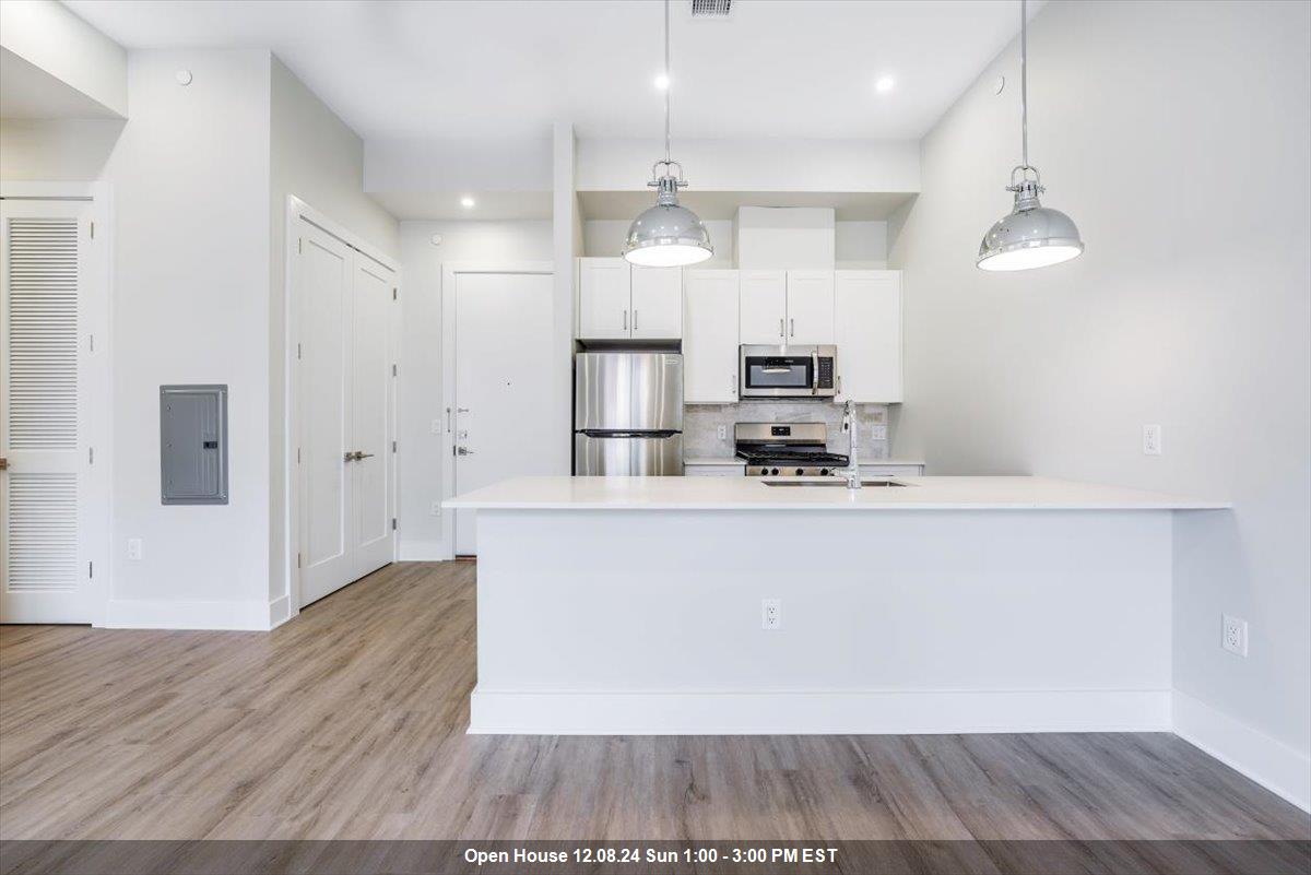 a view of kitchen with cabinets and wooden floor