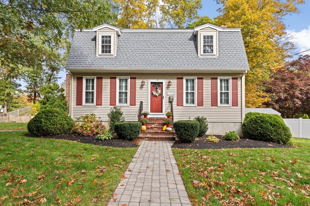 a front view of a house with a yard