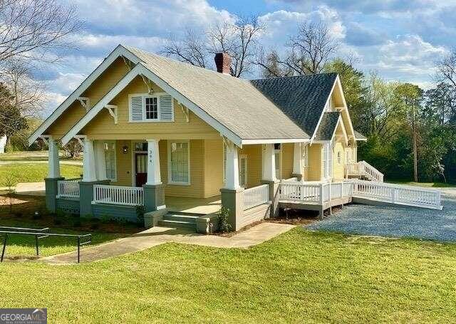 a front view of a house with a yard table and chairs