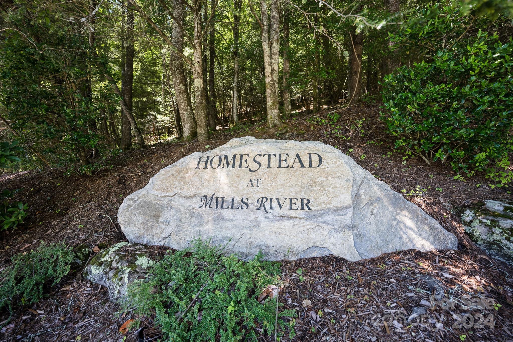 a sign that is sitting on a rock