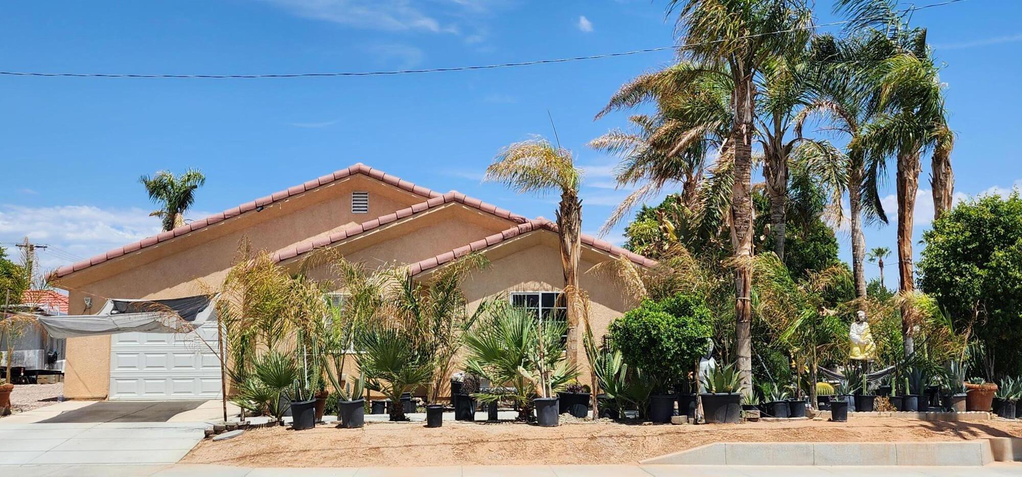 a front view of a house with a tree