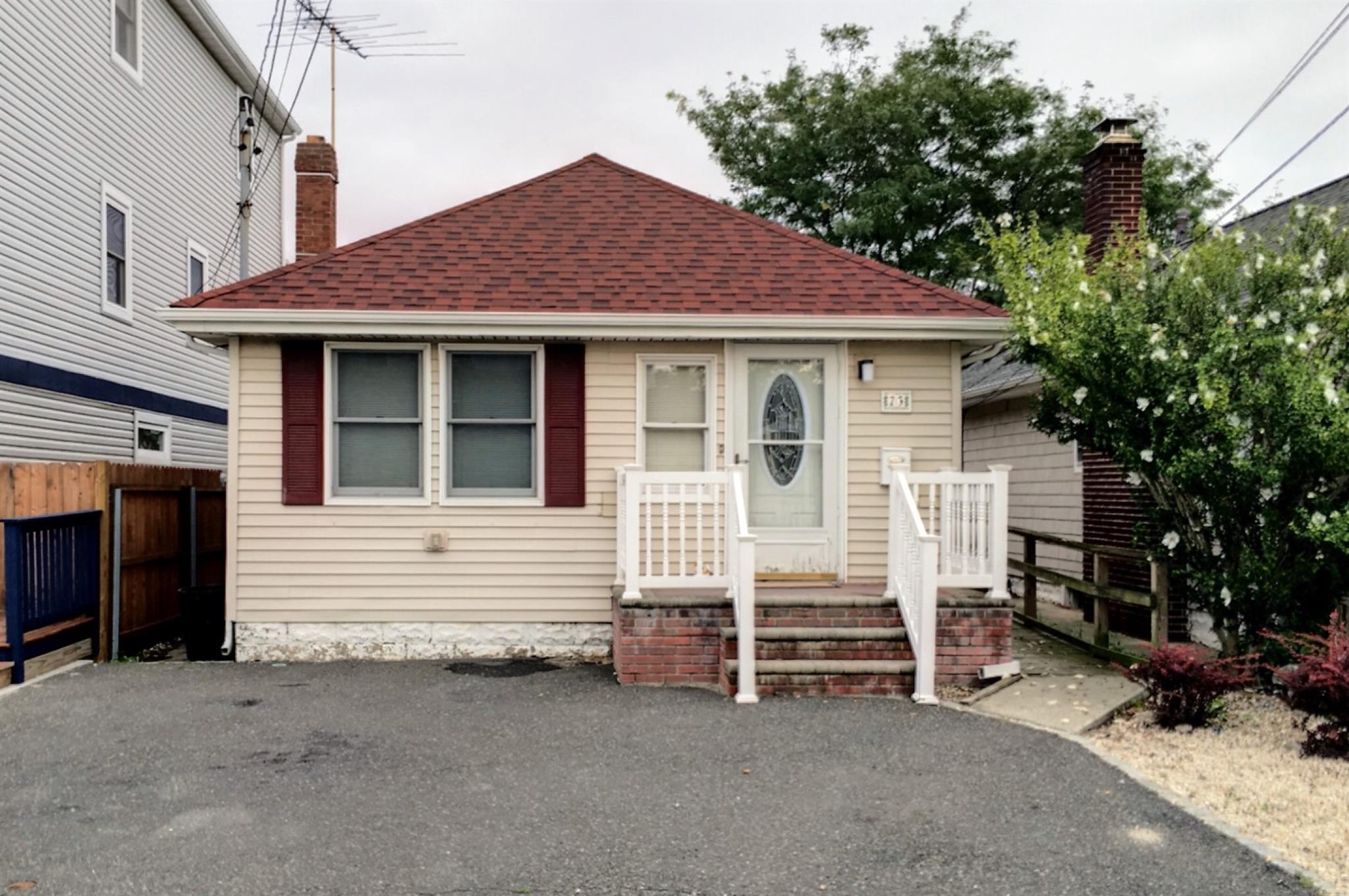 a view of house with a yard and garage