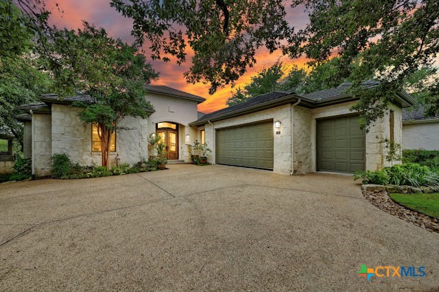 a front view of a house with a yard and garage