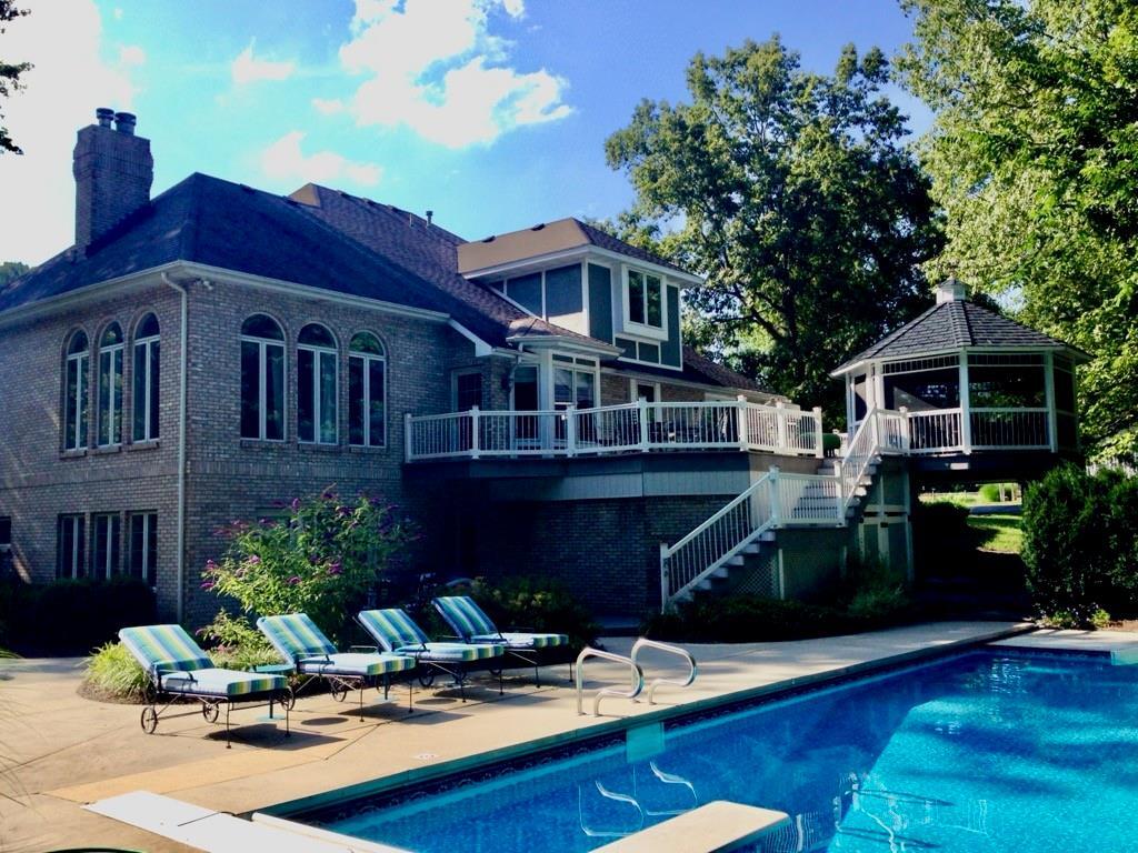 a view of a house with pool and sitting area