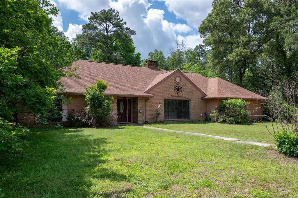 a front view of a house with yard and green space