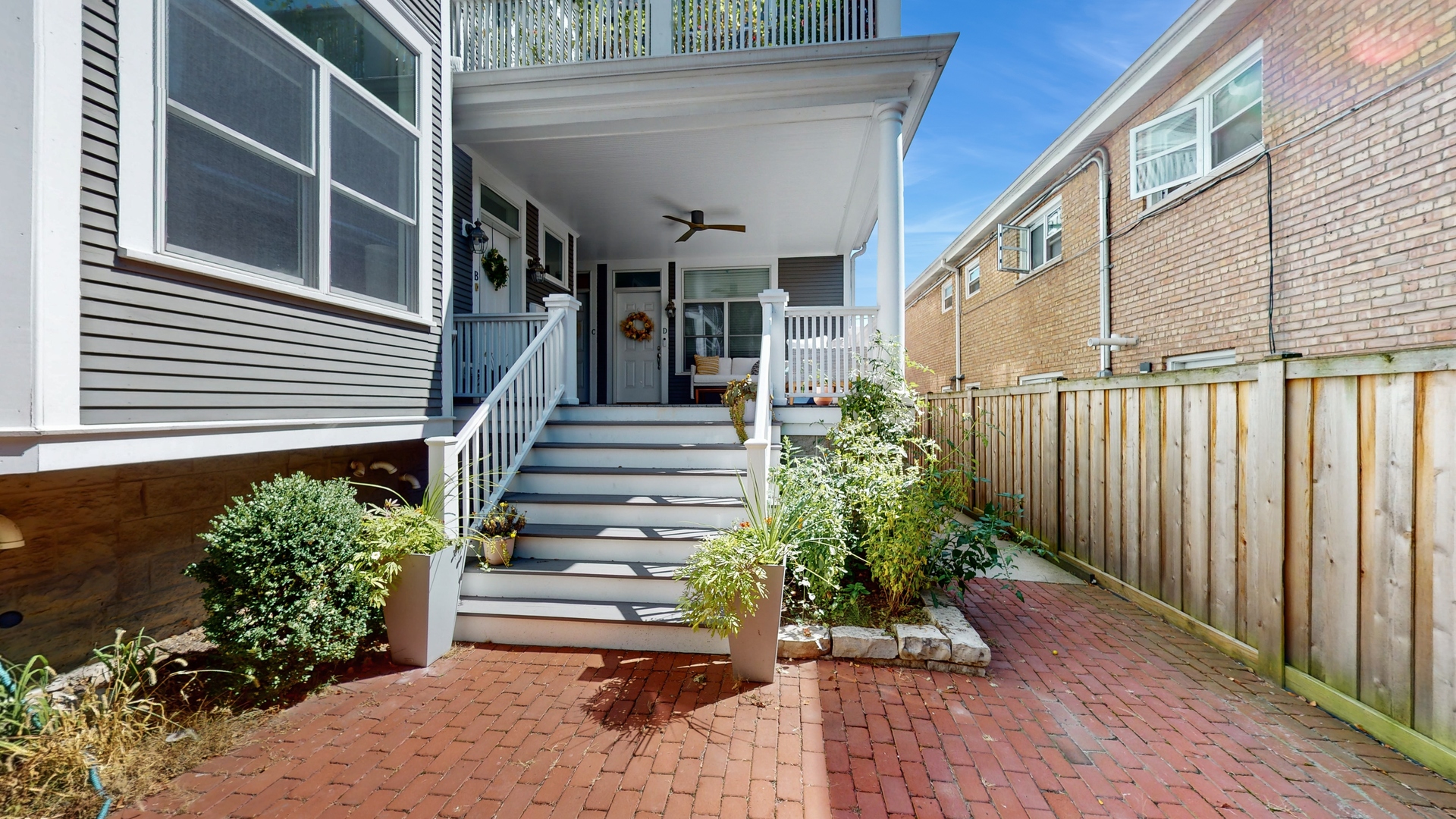 a view of a house with stairs and flowers