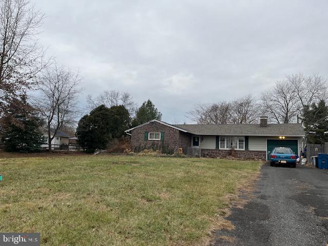 a view of a house with a yard and large trees