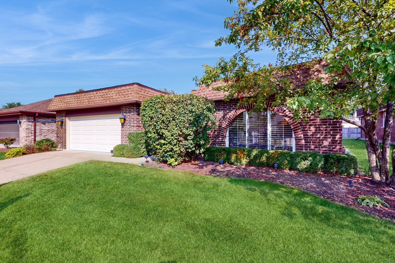 a front view of a house with a garden