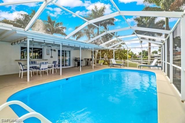 a view of a swimming pool with outdoor seating