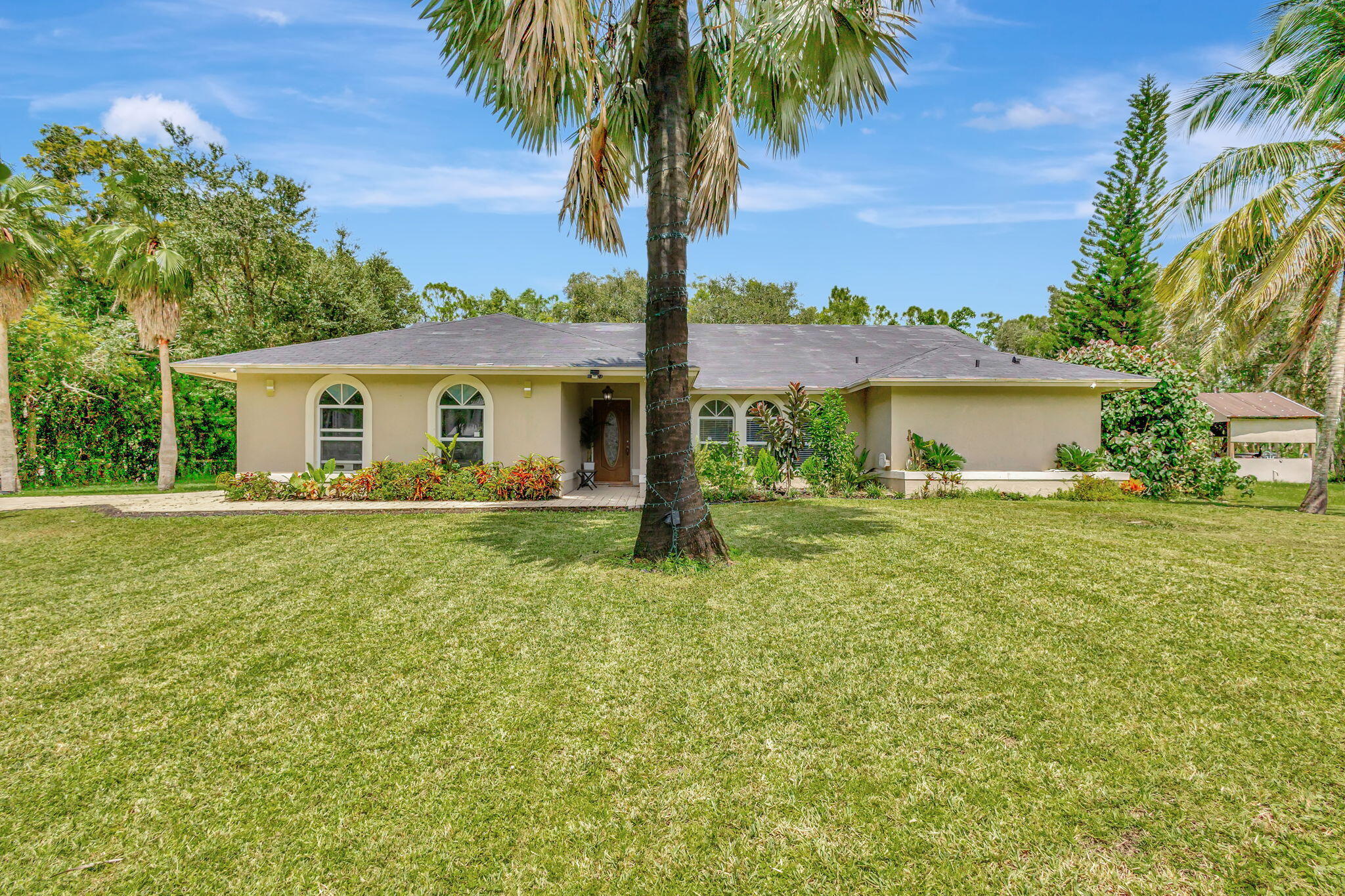 a front view of house with yard and trees