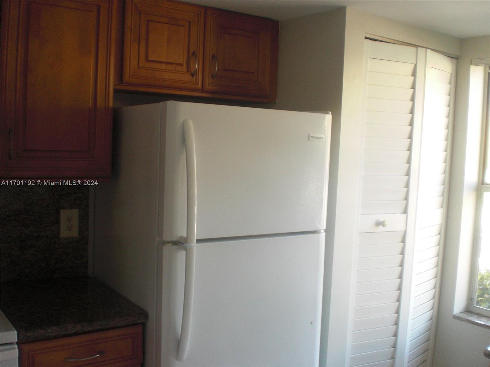 a white refrigerator freezer sitting in a kitchen