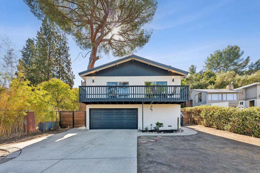 a front view of a house with yard and parking