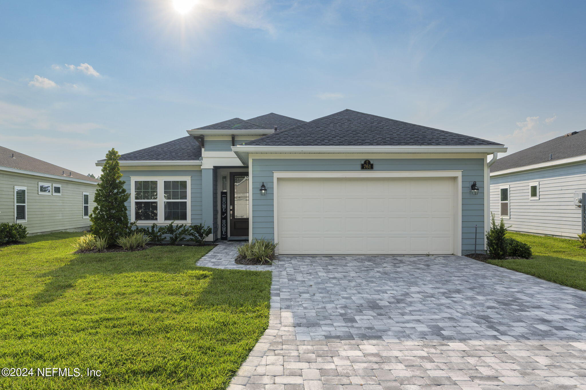 a front view of a house with garden