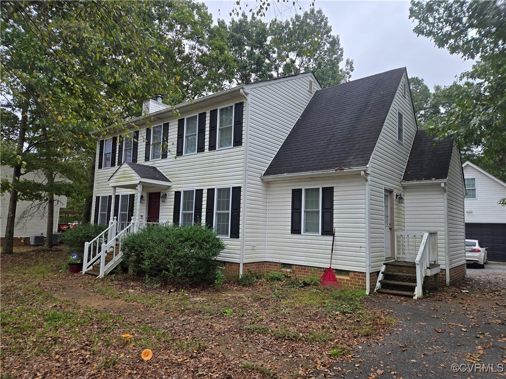 Colonial-style house featuring a garage