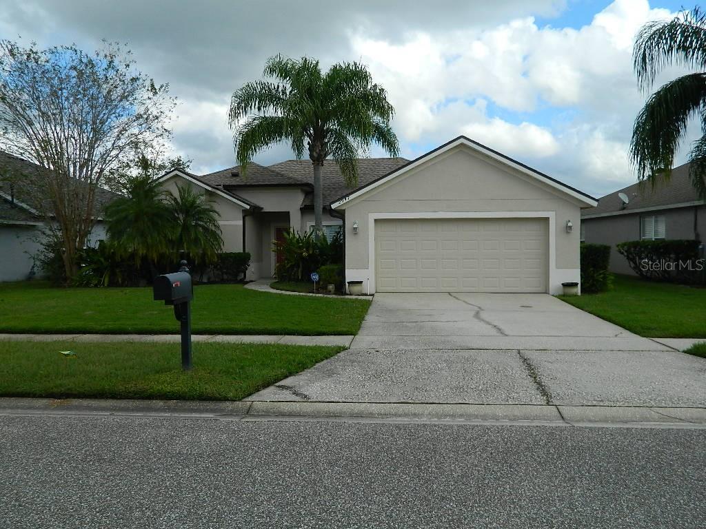 a front view of house with yard and green space