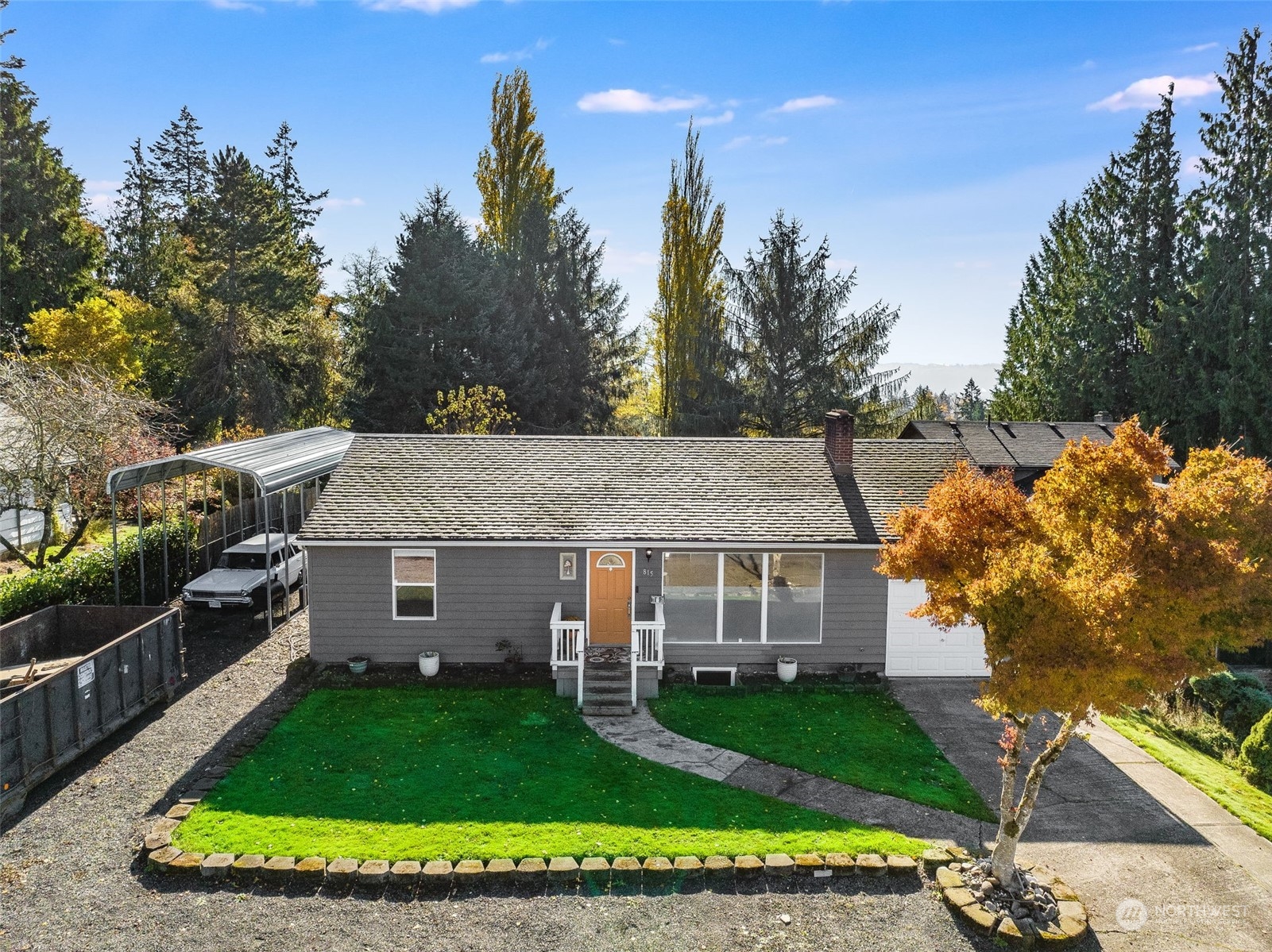 a aerial view of a house with a yard table and chairs