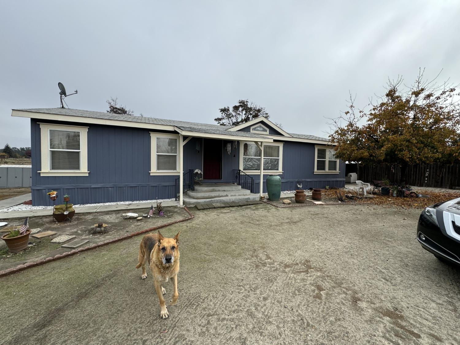 a front view of a house with cars parked