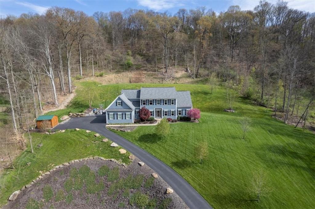 a view of house with a big yard