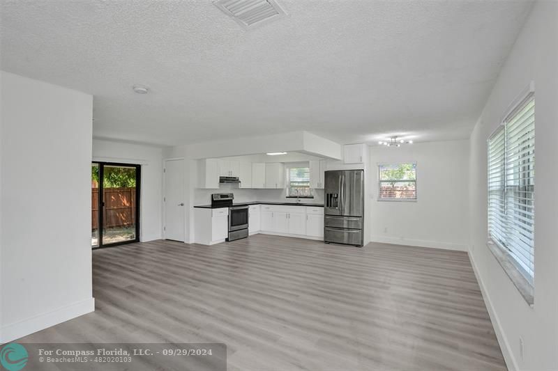 a view of a kitchen with wooden floor