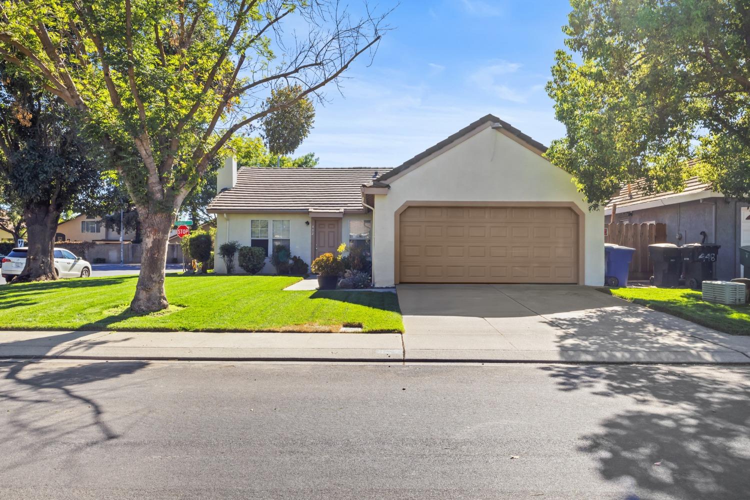 a view of front a house with a yard and garage