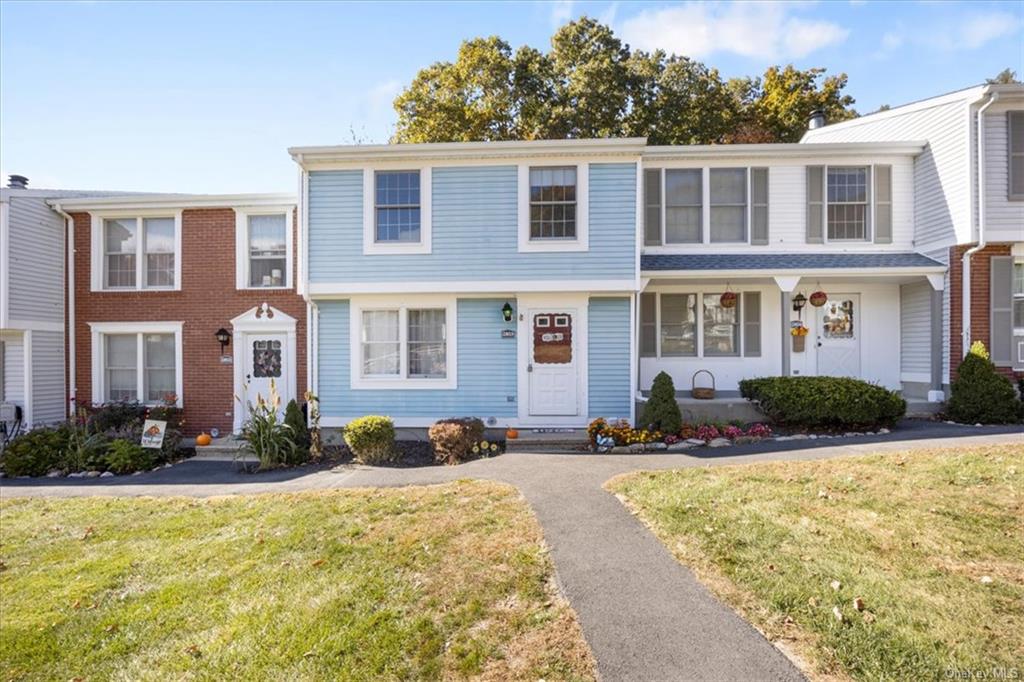 View of property with a front yard