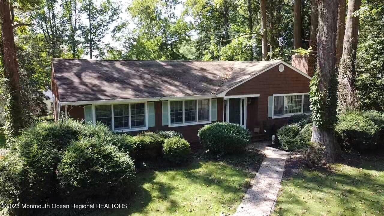 a view of house with yard and outdoor seating