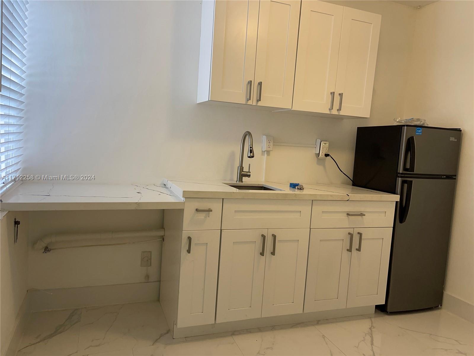 a kitchen with cabinets and white appliances