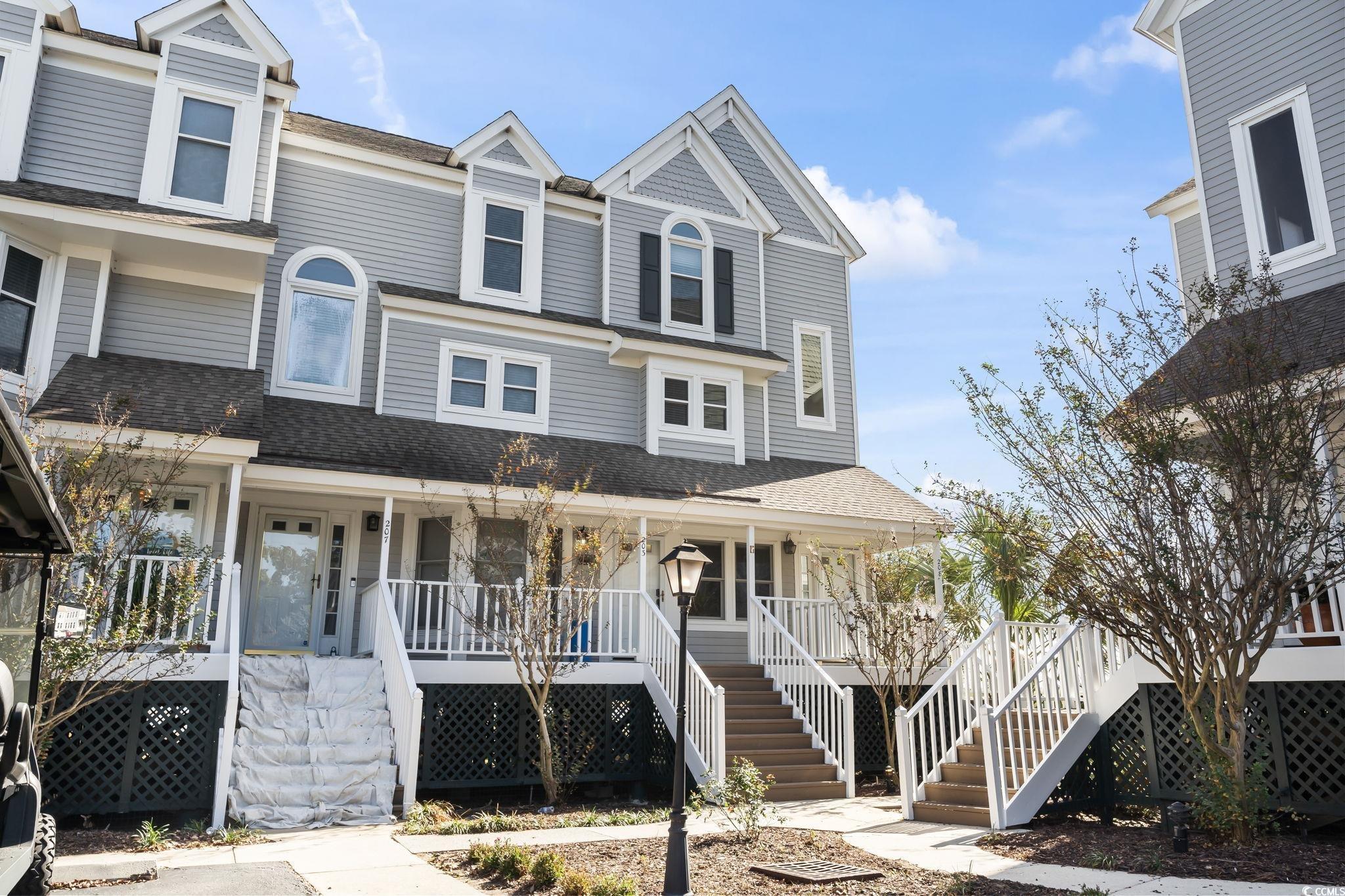 Townhome / multi-family property featuring a porch