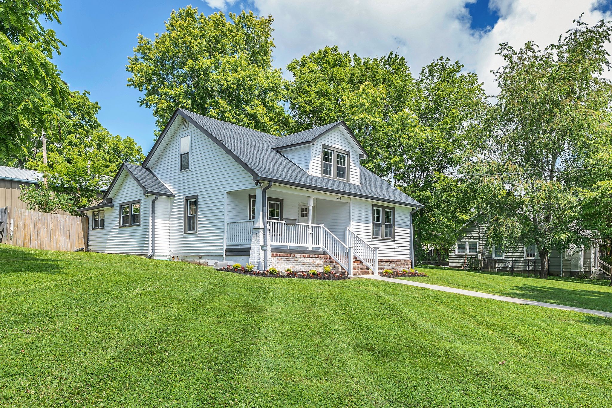 a front view of house with yard and green space