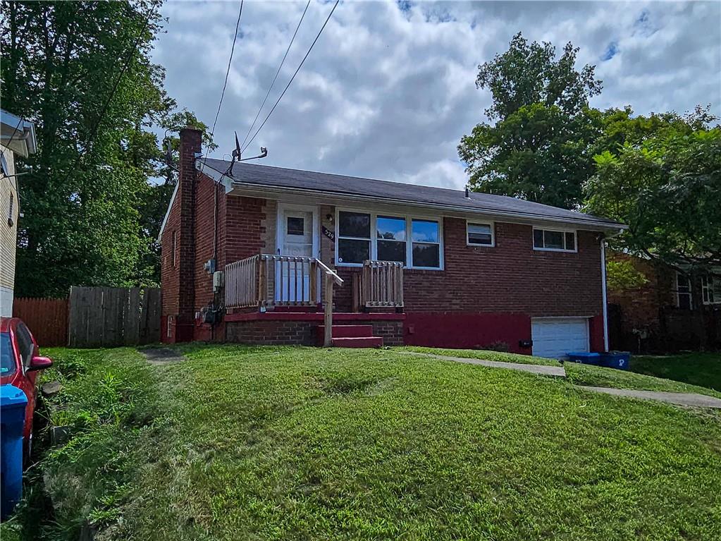 a view of a house with a yard and sitting area