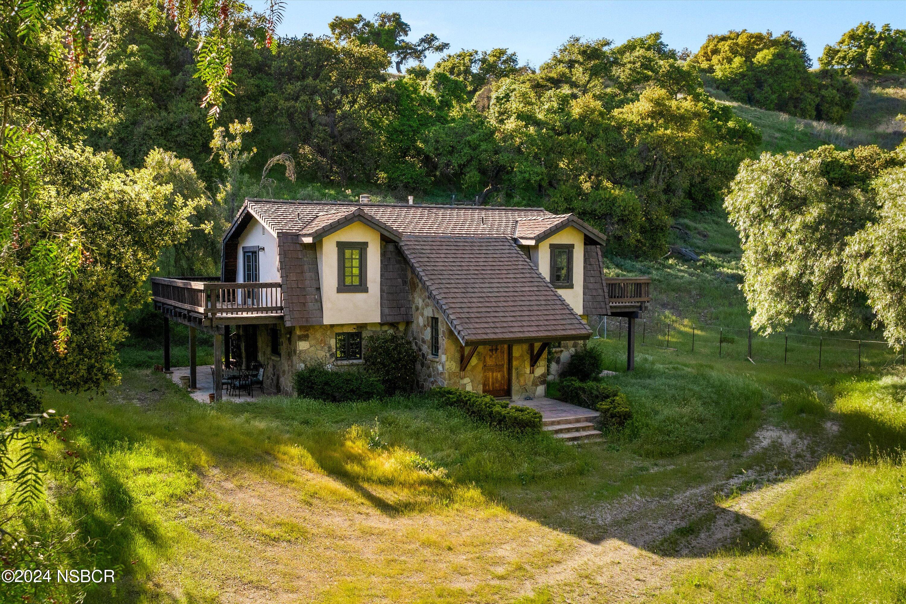 a front view of a house with yard patio and green space