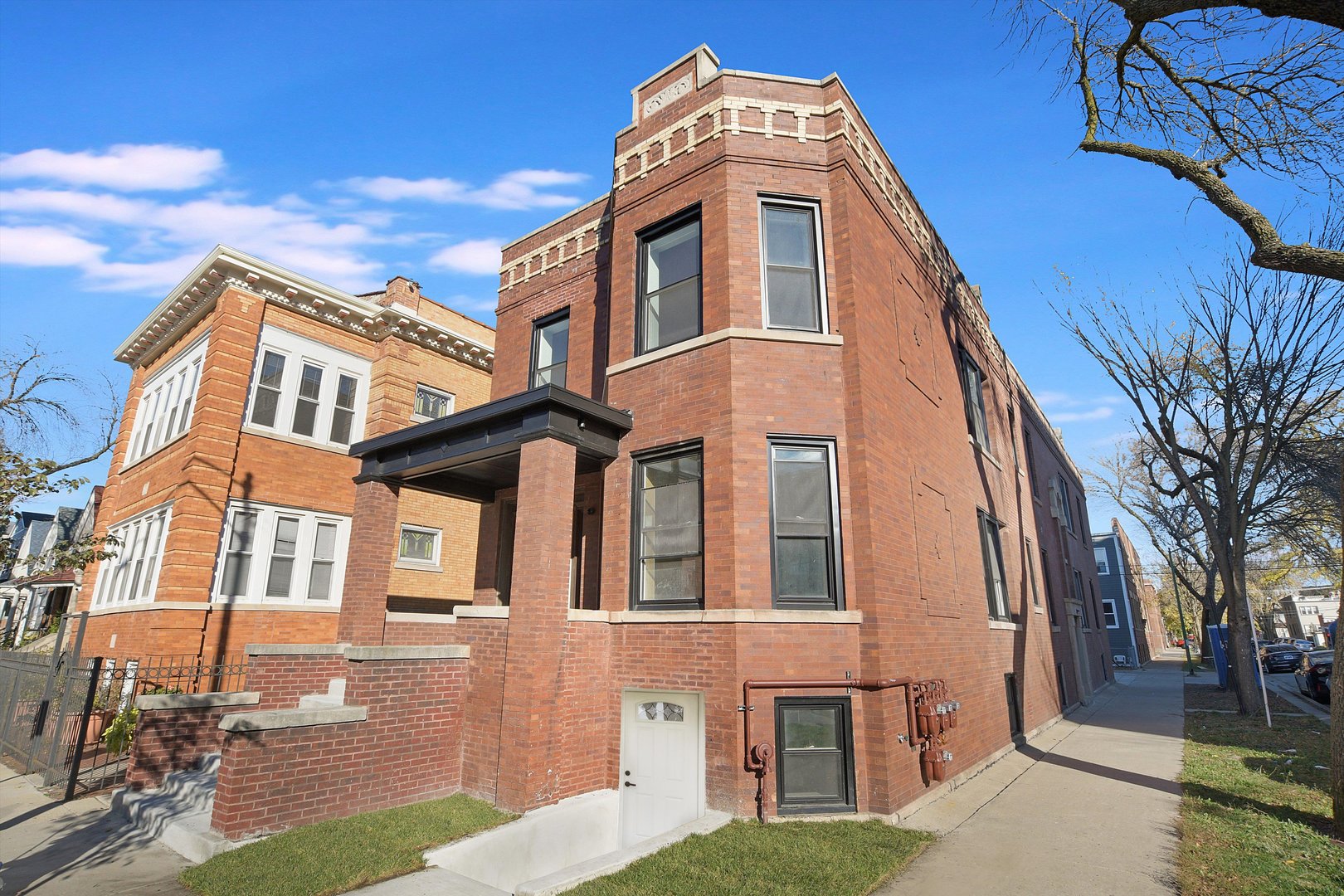 a front view of a residential apartment building with a yard