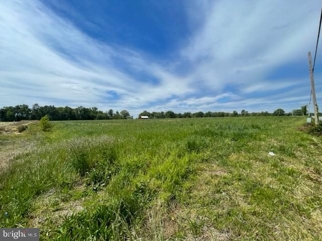 a view of a green field with an outdoor space