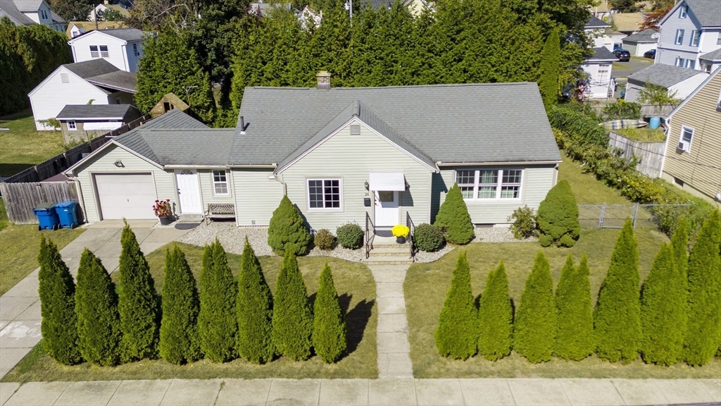 an aerial view of a house with a yard