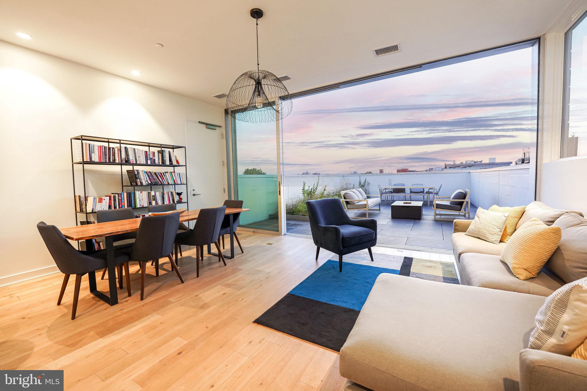 a living room with lots of furniture and a wooden floor