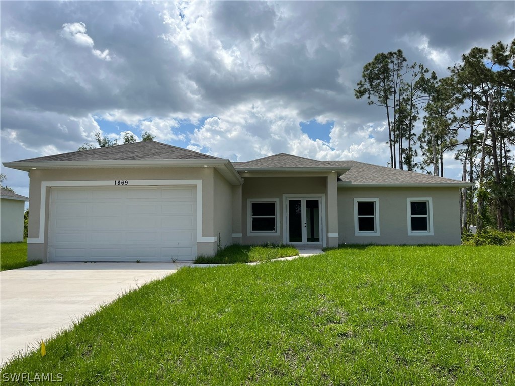 a view of a house with a garden and yard