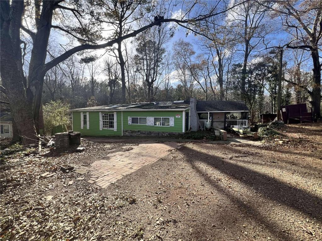 a view of a house with a yard and tree s