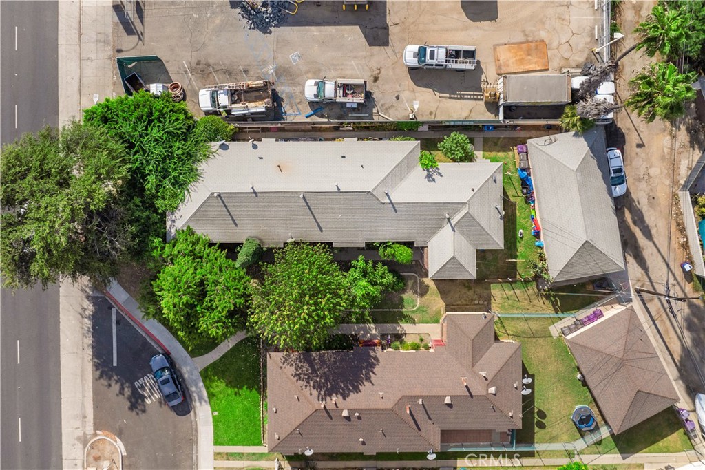 an aerial view of multiple houses with yard