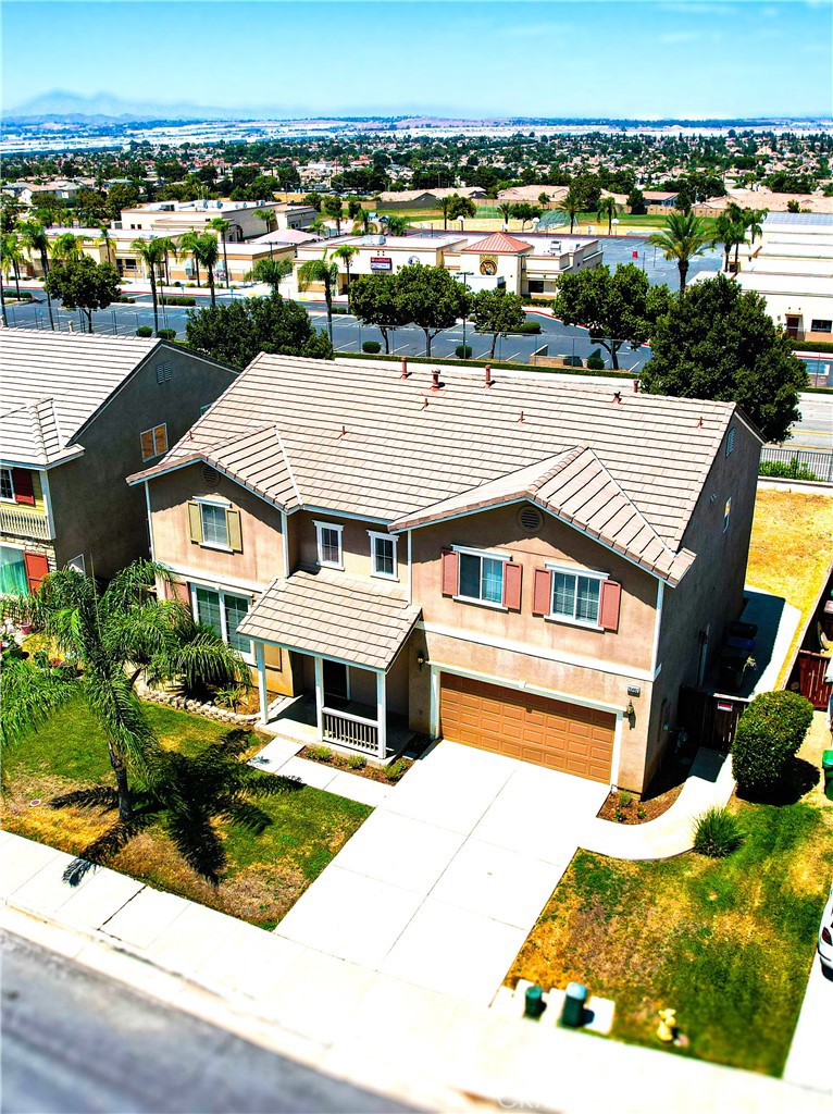 an aerial view of a house with a yard